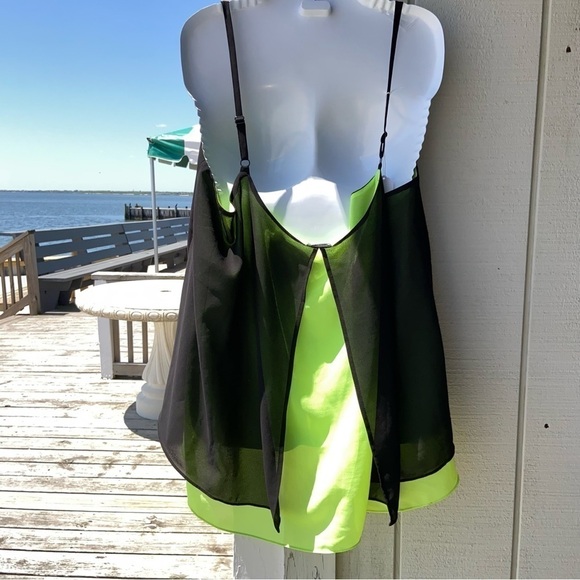 Black and chartreuse glossy top with adjustable straps, and a flowing open back. - Picture 2 of 5
